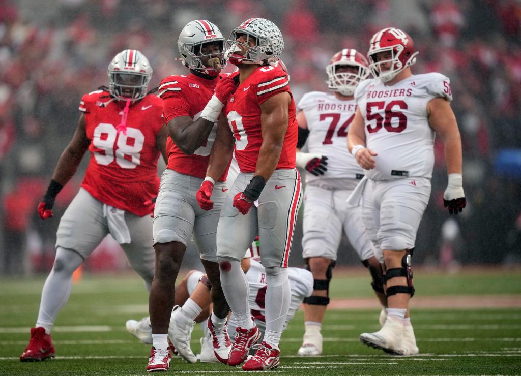 Buckeyes linebacker Cody Simon (0) celebrates his sack of Indiana Hoosiers quarterback Kurtis Rourke (9) with Ohio State Buckeyes defensive end Kenyatta Jackson Jr. (97) during the second quarter of the football game in Columbus on Saturday, Nov. 23, 2024.