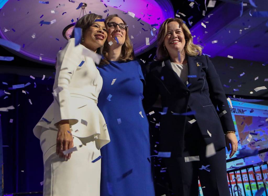 US Senator-elect Lisa Blunt Rochester (left), Congresswoman-elect Sarah McBride (center) and Delaware Lieutenant Governor-elect Kyle Evans Gay celebrate in front of supporters at the Chase Center on the Riverfront on election night.