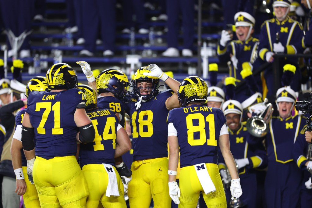 Colston Loveland #18 of the Michigan Wolverines celebrates with teammates after catching a pass for a touchdown during the second quarter against the Michigan State Spartans