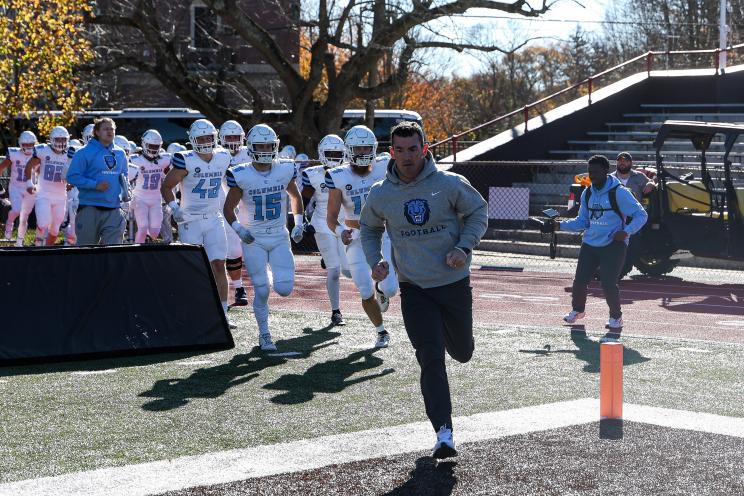 Columbia head coach Jon Poppe leads his team onto the field for a game against Brown on Nov. 16, 2024.