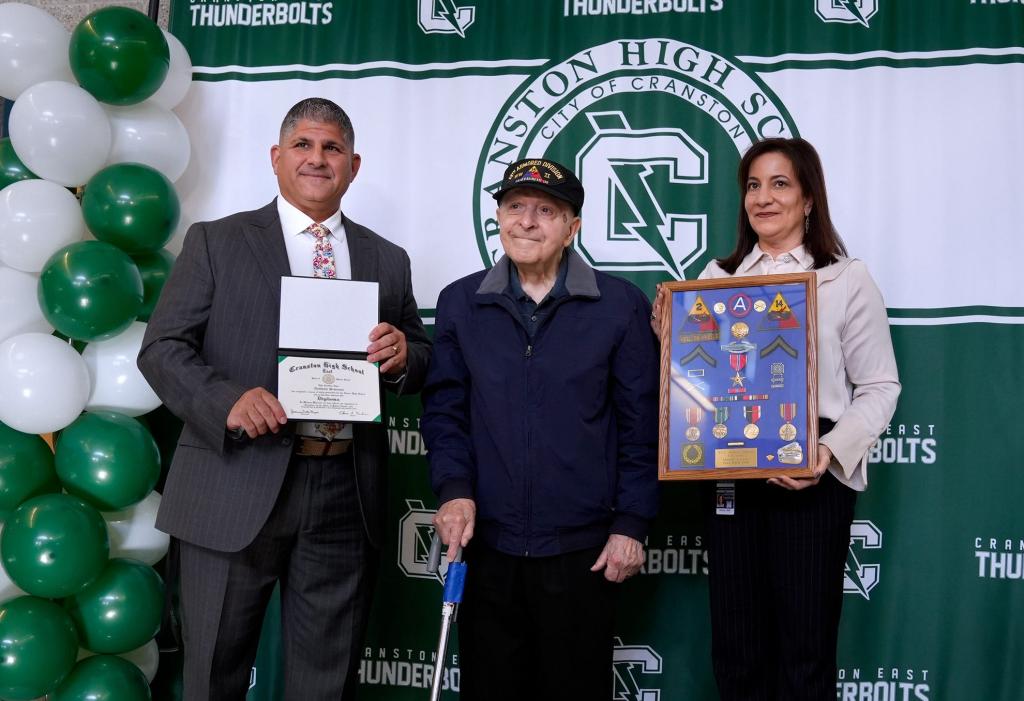 Simeone posing with his diploma.