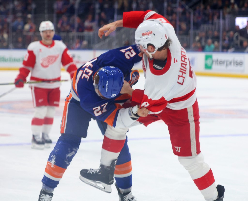 New York Islanders left wing Anders Lee (27) and Detroit Red Wings defenseman Ben Chiarot (8) fight during the third period when the New York Islanders played the Detroit Red Wings Monday, November 25, 2024 at UBS Arena in Elmont, NY. 