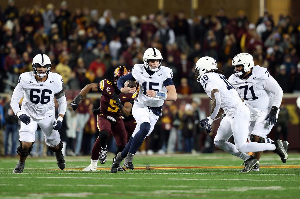 Drew Allar #15 of the Penn State Nittany Lions runs with the ball against the Minnesota Golden Gophers in the fourth quarter at Huntington Bank Stadium on November 23, 2024 in Minneapolis, Minnesota.