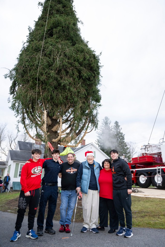 Earl Albert, center right, poses with his son Michael Albert and daughter-in-law Shawn Albert, with their three children, in front of the wrapped 74-foot tall Norway Spruce that the family donated to serve as this year's Rockefeller Center Christmas Tree, Thursday, Nov. 7, 2024, in West Stockbridge, MA