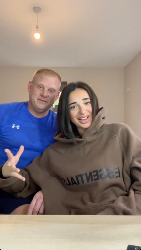 A man and woman posing for a picture while interacting with beauty products