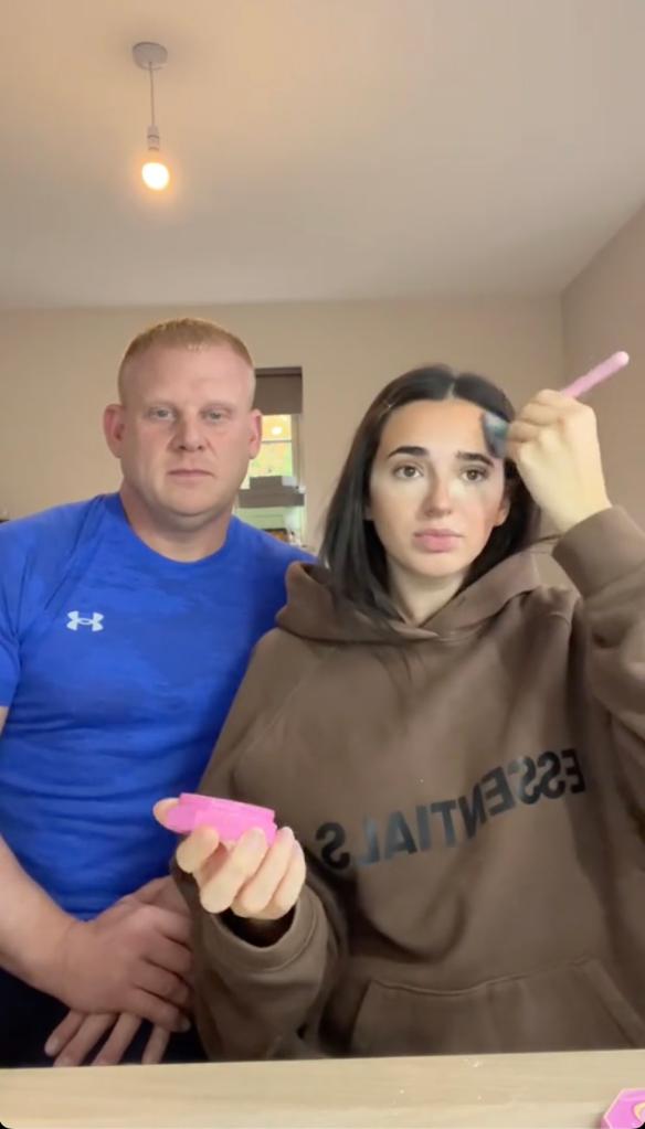 Man and woman holding a brush and pink beauty product, captured in a clip where the man is guessing the price of the beauty product.