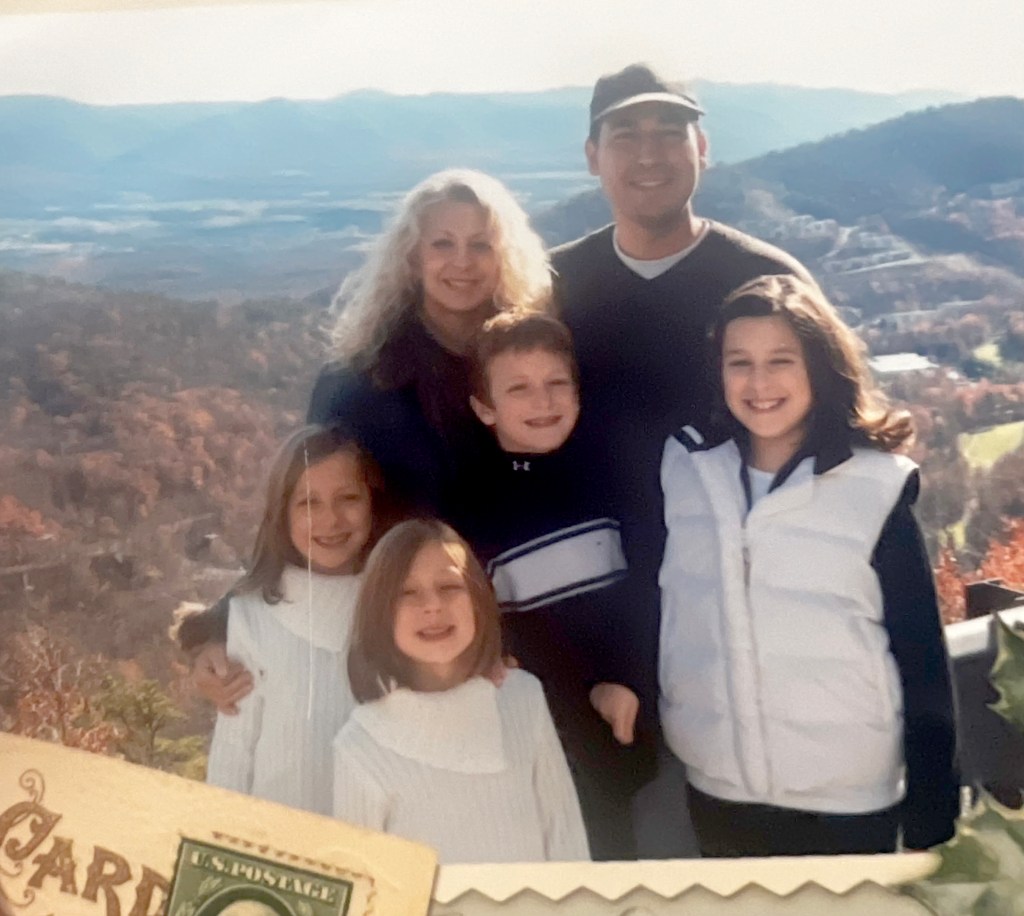 Daniel Penny with his parents and sisters in an old family photograph.