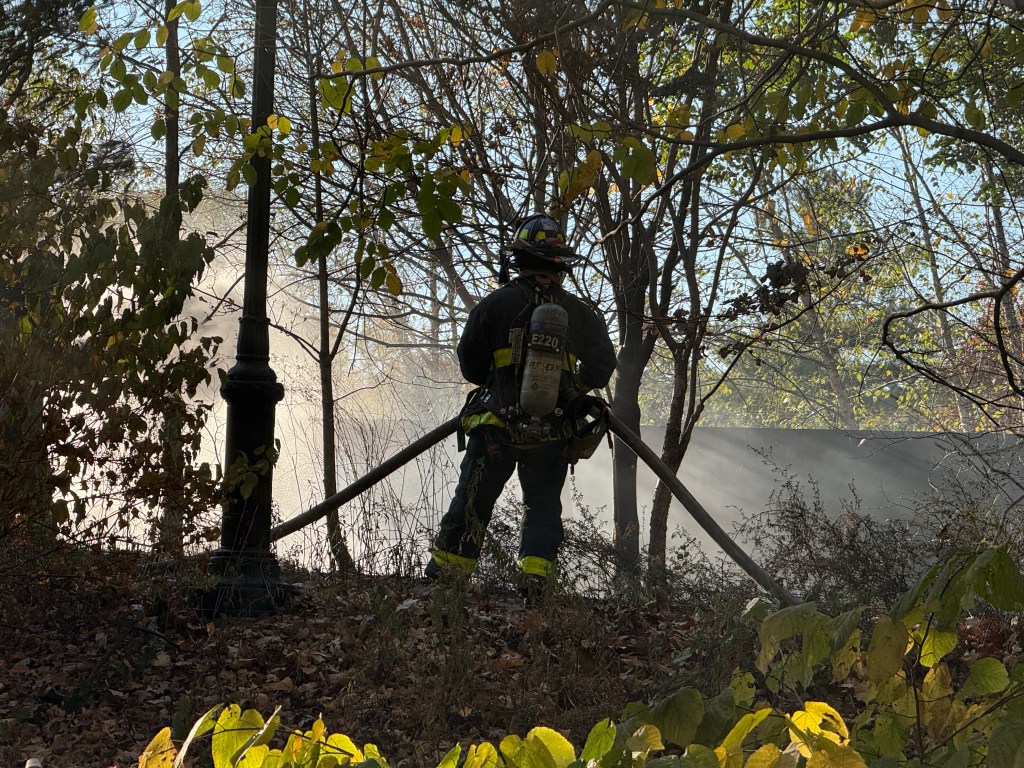 Firefighters are seen putting out a small brush fire in Prospect Park in Brooklyn, Saturday, Nov. 9, 2024.