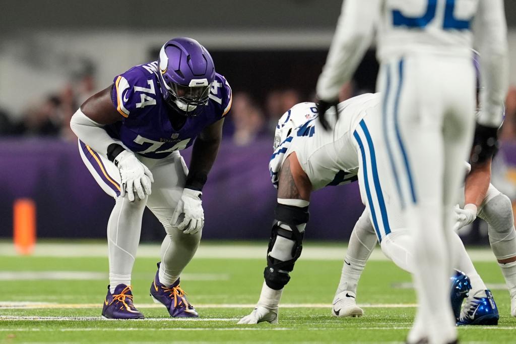 Minnesota Vikings offensive tackle Cam Robinson (74) gets set for a play during the second half of an NFL football game against the Indianapolis Colts, Sunday, Nov. 3, 2024, in Minneapolis. 