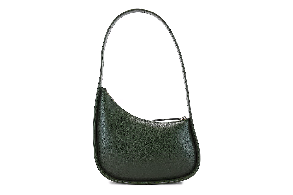 A green half moon shaped purse on a white background