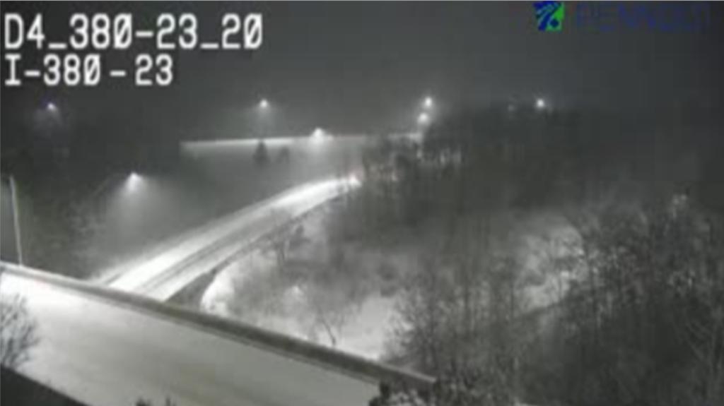 Snow falling heavily on I-380 at Exit 24 in Pennsylvania, causing difficult travel conditions.