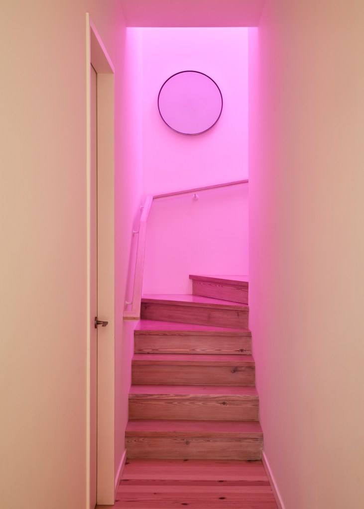 A filter over a window and skylight adds a chic pink glow that warms up the home