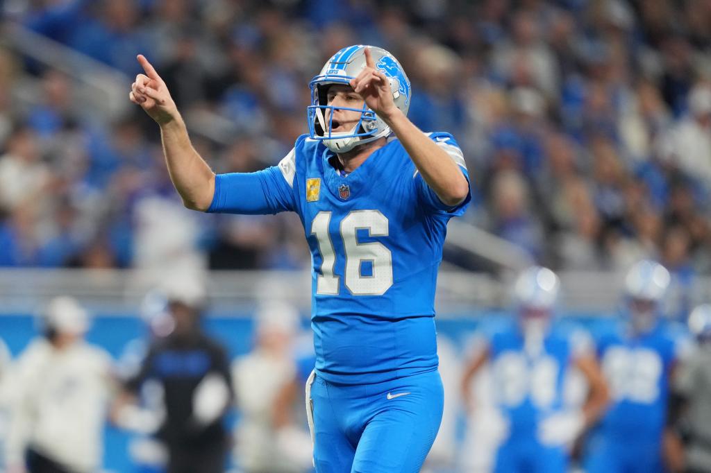 Jared Goff #16 of the Detroit Lions in blue uniform, calling out a play during a game against the Jacksonville Jaguars at Ford Field.