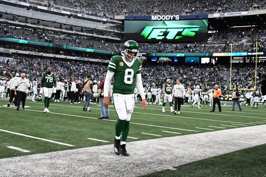 Aaron Rodgers walks off the field following the Jets' loss to the Colts on Nov. 17.