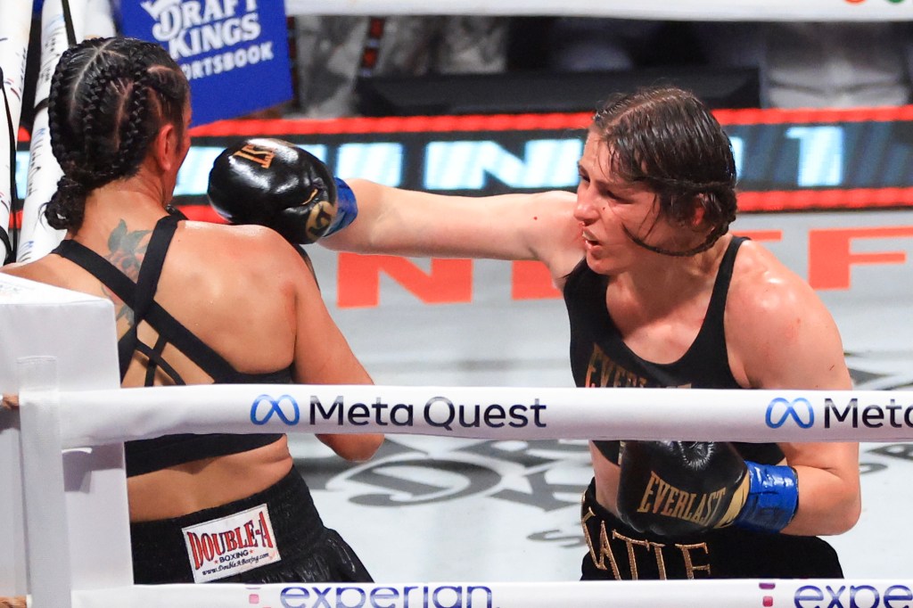 Katie Taylor (R) punches Amanda Serrano during their undisputed women's super lightweight title bout