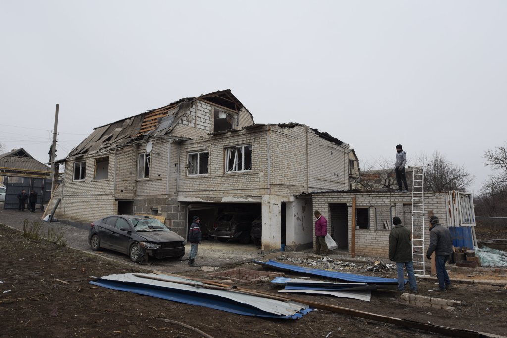 Local residents stand before a damaged house destroyed following shelling which local officials called a "Ukrainian military strike" in the town of Dokuchayevsk, in Donetsk region, Russian-controlled Ukraine, on November 29, 2024, amid the ongoing Russian-Ukrainian conflict.  (Photo by STRINGER / AFP) (Photo by STRINGER/AFP via Getty Images)
UKRAINE-RUSSIA-CONFLICT