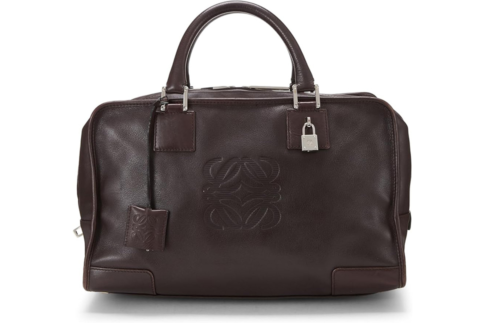 A brown leather bag with a logo on it