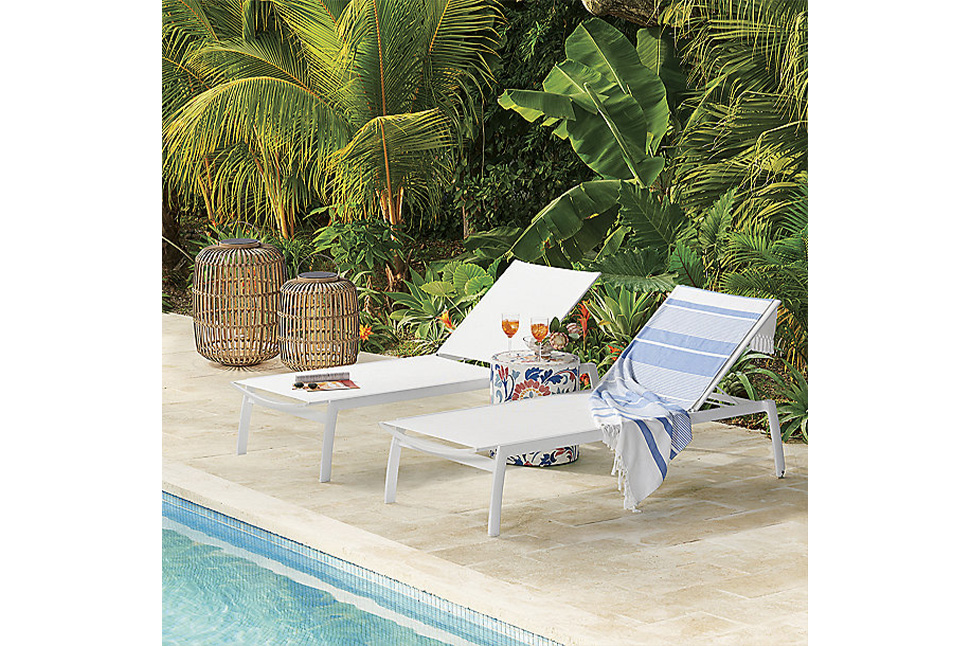 A pool with lounge chairs and a table