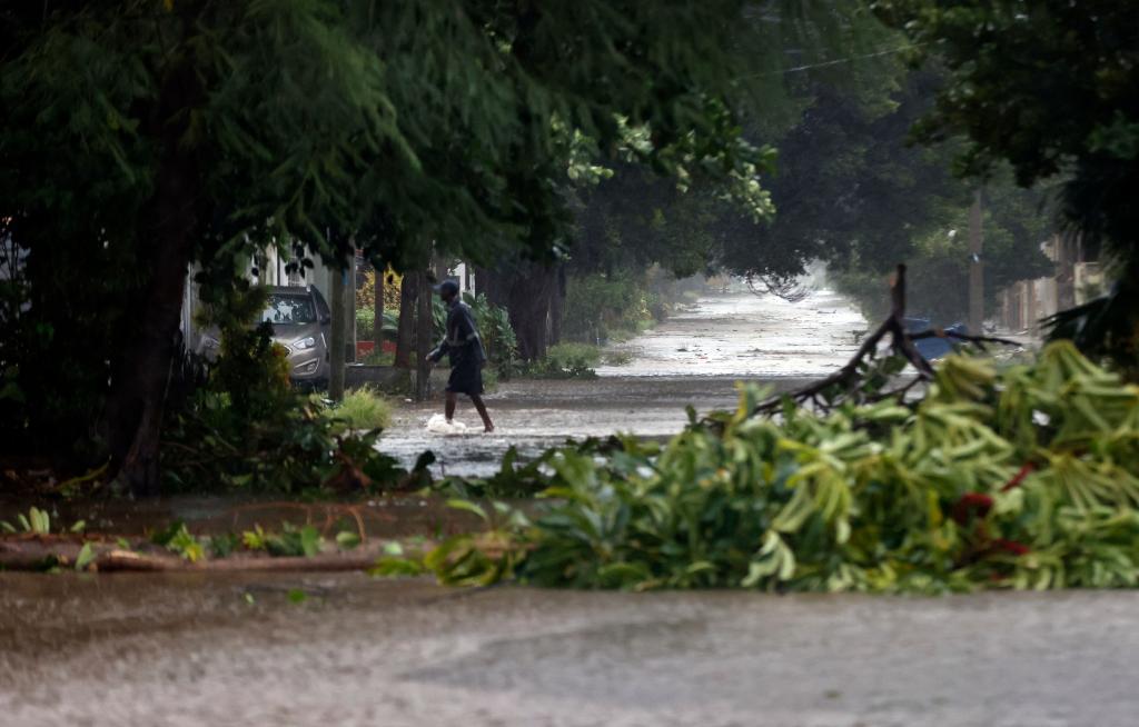 Debris lies in a flooded street in Havana, Cuba as Hurricane Rafael moves away from the island.