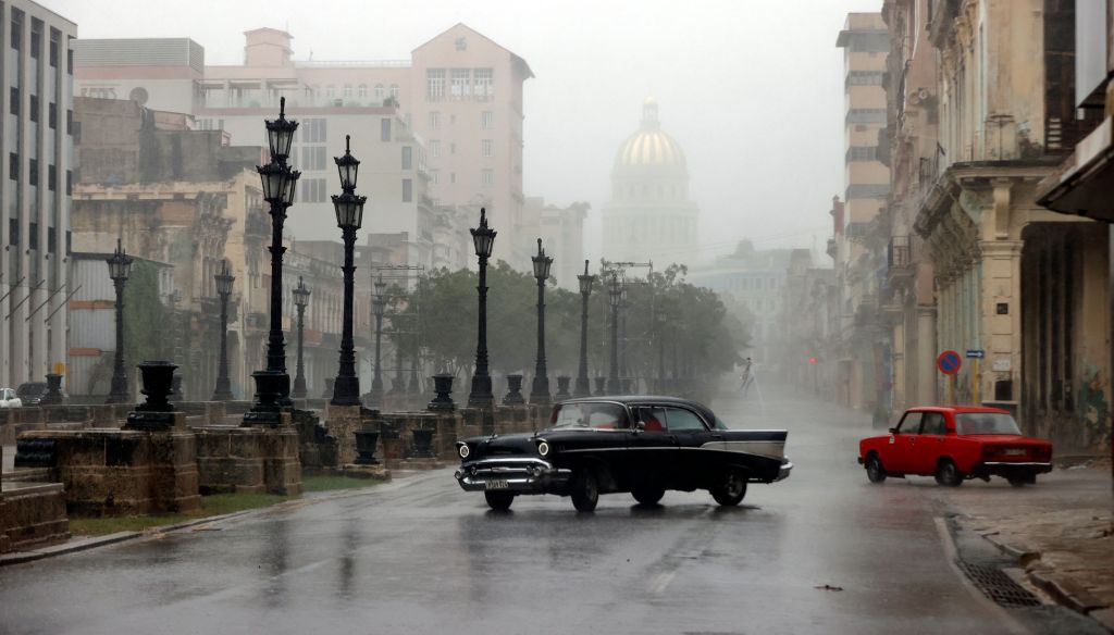 Cars drive on rain-filled streets during the hurricane on Wednesday.