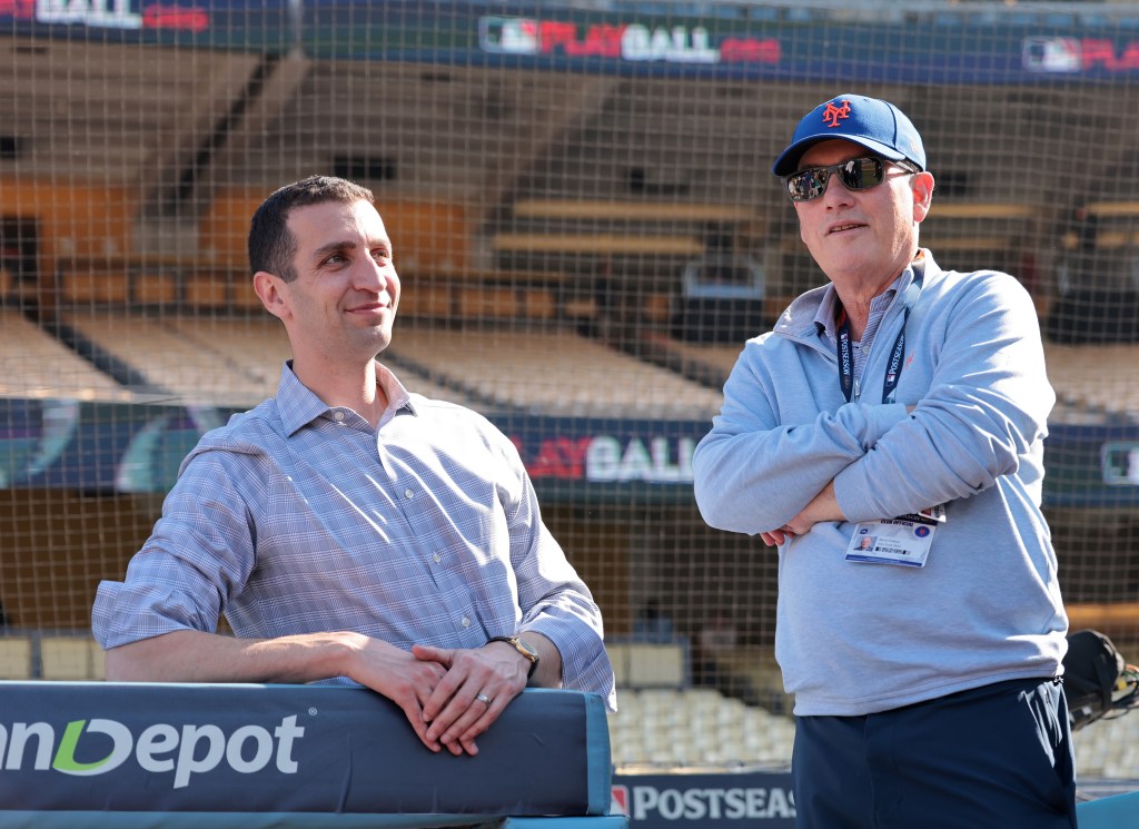 New York Mets owner Steve Cohen and team president David Stearns conversing on the field before the NLCS Game 1 at Dodger Stadium