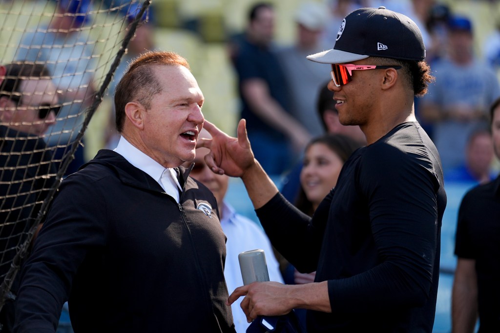 New York Yankees' player Juan Soto engaging in a discussion with agent Scott Boras before the start of Game 1 in the baseball World Series against the Los Angeles Dodgers, taken on October 25th, 2024 in Los Angeles.