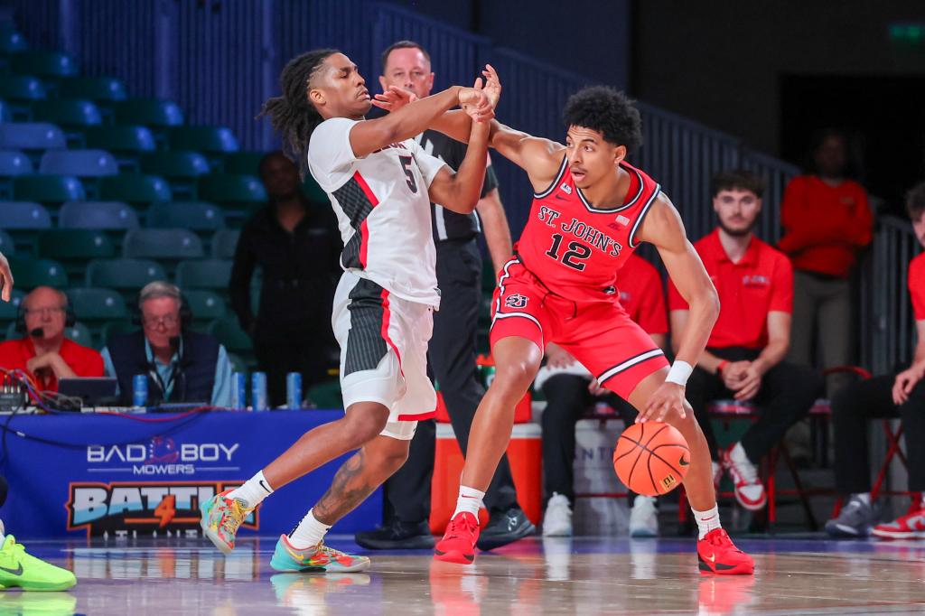 St. John's RJ Luis Jr. (12) controls the ball against Georgia's Silas Demary Jr. (5) during an NCAA college basketball game Sunday, Nov. 24, 2024, in Paradise Island, Bahamas. 