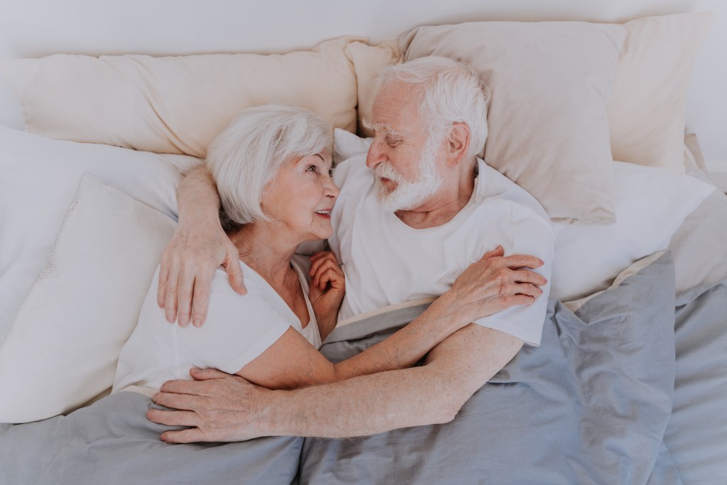 Older couple in bed together. 