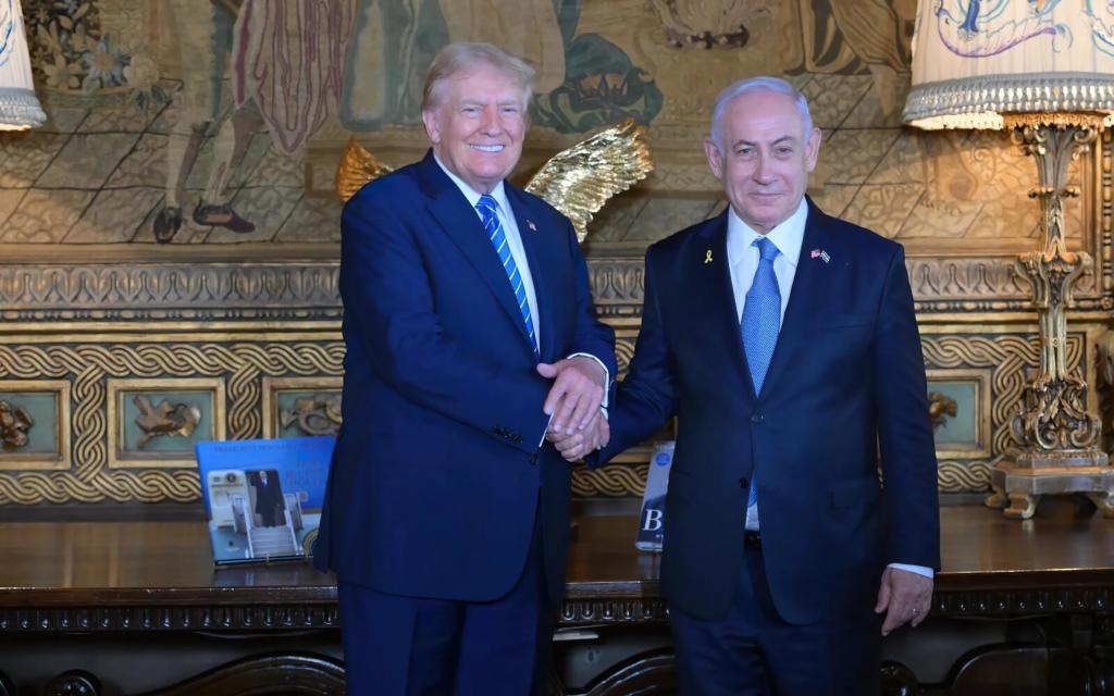 Former President Donald Trump (L) shakes hands with Israeli Prime Minister Benjamin Netanyahu (R) as they pose for a photo within their meeting at Mar-a-Lago estate, in Palm Beach, Florida, United States on July 26, 2024.