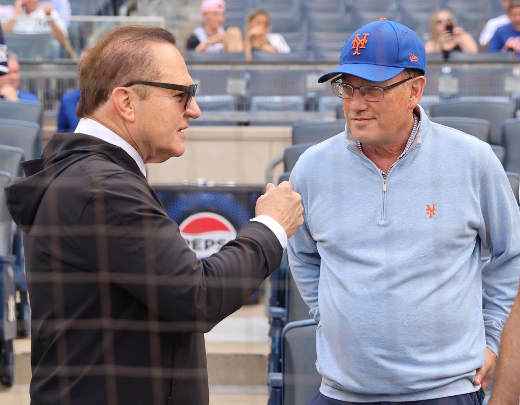 Sports agent Scott Boras conversing with Mets owner Steve Cohen in the stands at Yankee Stadium before a Mets vs. Yankees game.