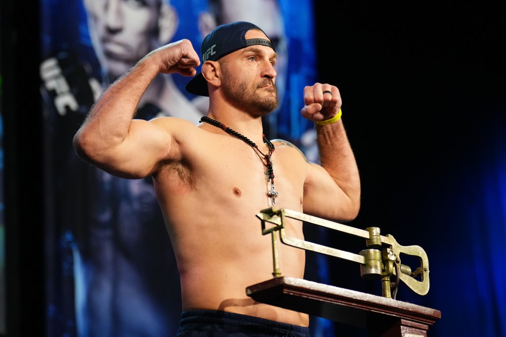 Stipe Miocic poses on the scale during the UFC 309 ceremonial weigh-in at The Theater at Madison Square Garden on November 15, 2024 in New York City.