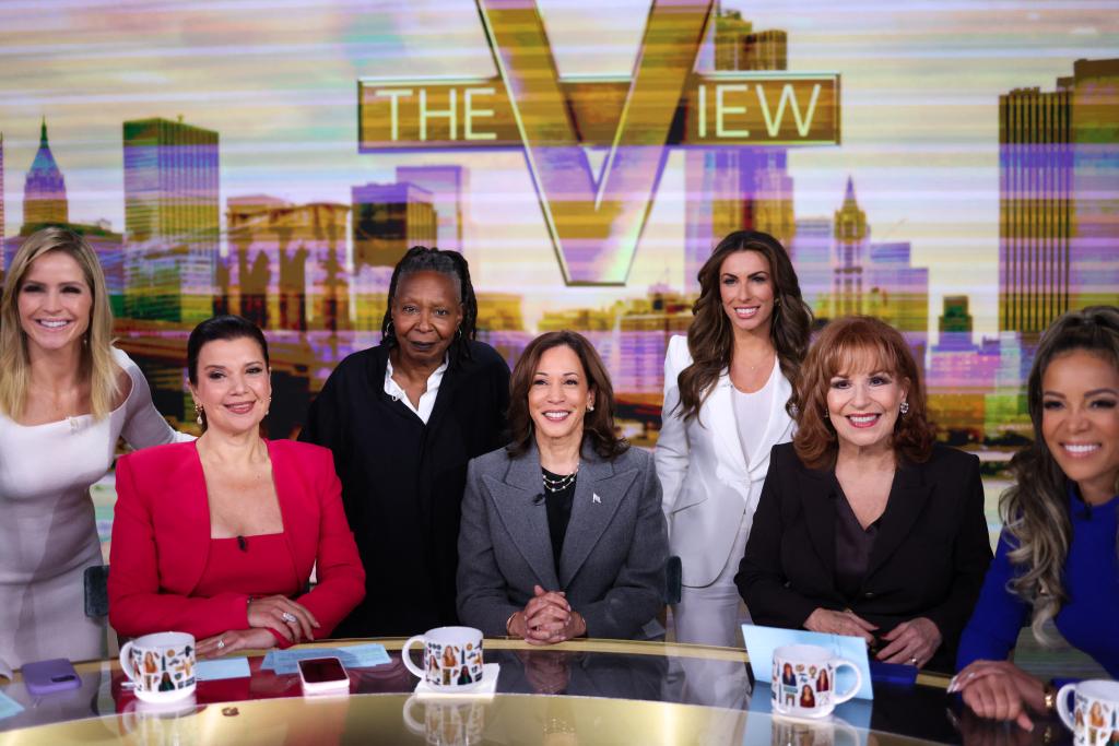 The cast of the view, sitting around the table with Kamala Harris on set. 