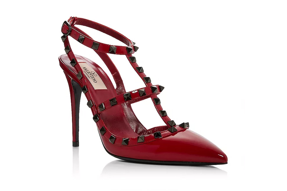 A red high heeled shoe adorned with black spikes