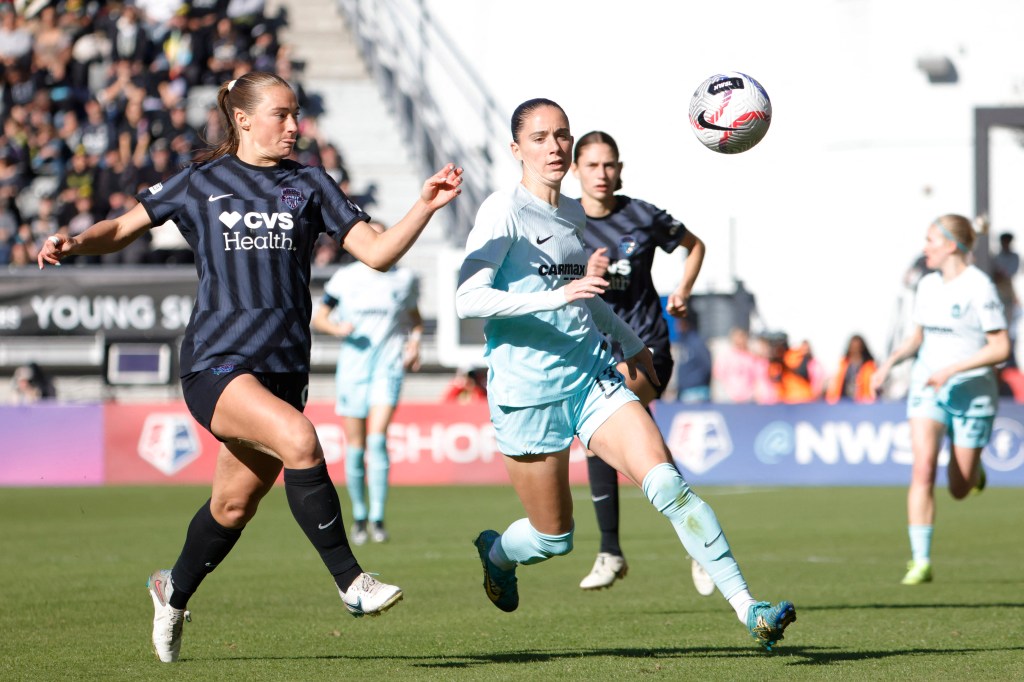 Washington Spirit defender Tara McKeown (9) and NJ/NY Gotham FC forward Ella Stevens (13) battle for the ball in the second half in a 2024 NWSL Playoffs semifinal match at Audi Field. 