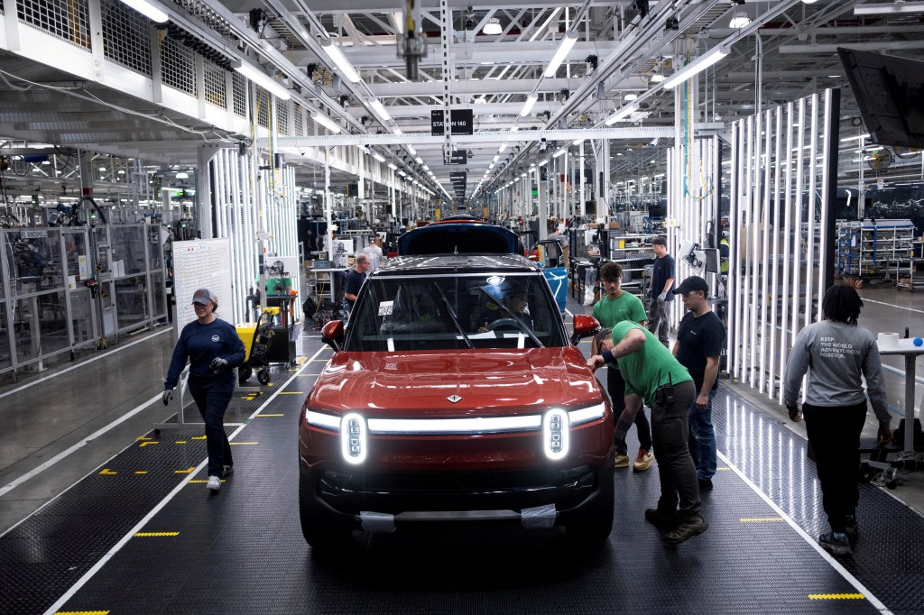 Workers assembling second-generation R1 vehicles at Rivian's electric auto manufacturing facility in Normal, Illinois