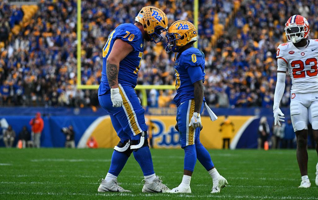 Desmond Reid #0 of the Pittsburgh Panthers celebrates with Ryan Baer #70 after rushing for a first down in the fourth quarter of a game against the Clemson Tigers at Acrisure Stadium on Nov. 16, 2024.