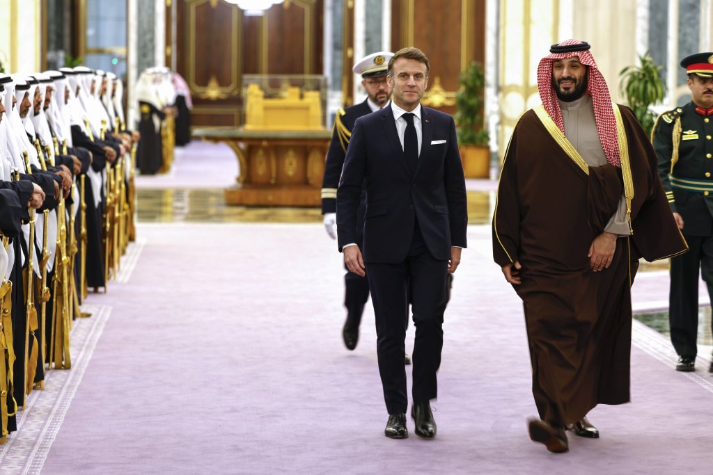 French President Emmanuel Macron walking next to Saudi's Crown Prince Mohammed Bin Salman in Riyadh on December 2, 2024