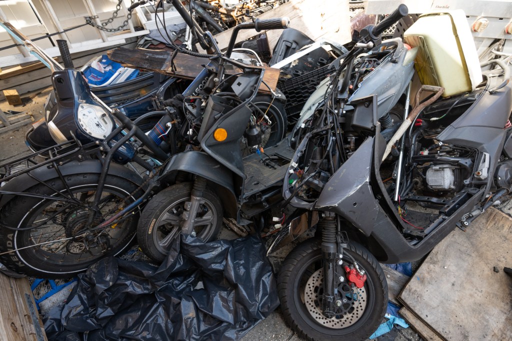 Scooters and e-bikes stored in a Brooklyn backyard in August.