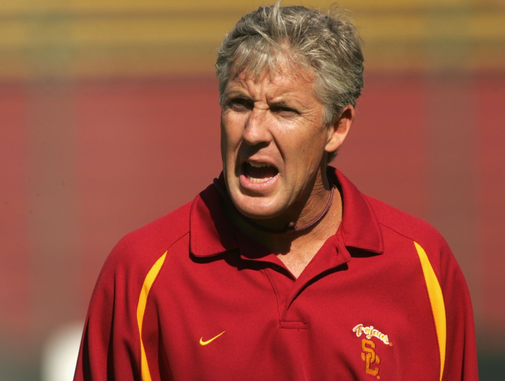 Head coach Pete Carroll of the USC Trojans exhorts his team in warmups before the game against the Stanford Cardinal on September 25, 2004 at Stanford Stadium in Palo Alto, California.  