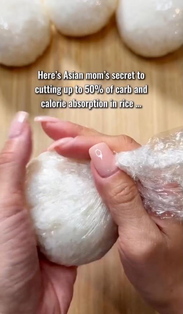 A person holding a plastic wrap, demonstrating an 'Asian mom secret' to cut carbs from rice, pasta, and bread