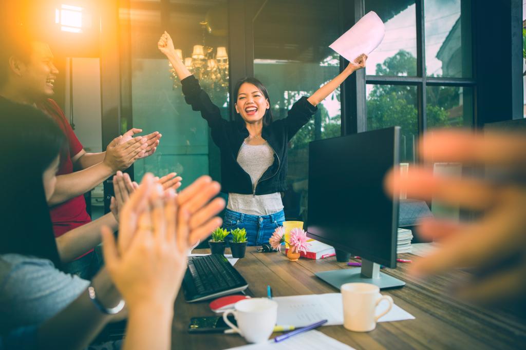 Researchers in Norway assessed the passion, grit and mindset of over 1,500 participants to determine which personality traits are needed to become good at something. Here, a woman celebrates achievement at the office.