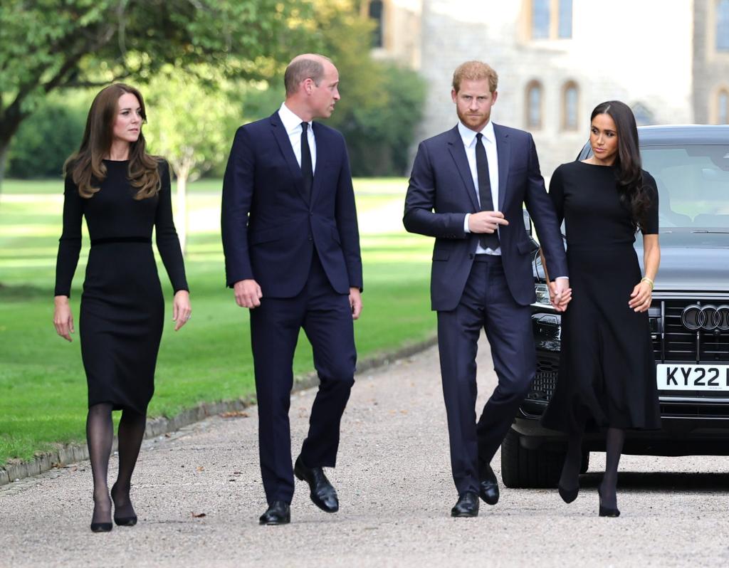 Prince William, Prince Harry, Meghan, Duchess of Sussex, and Catherine, Princess of Wales walking towards Windsor Castle to view tributes to Queen Elizabeth II