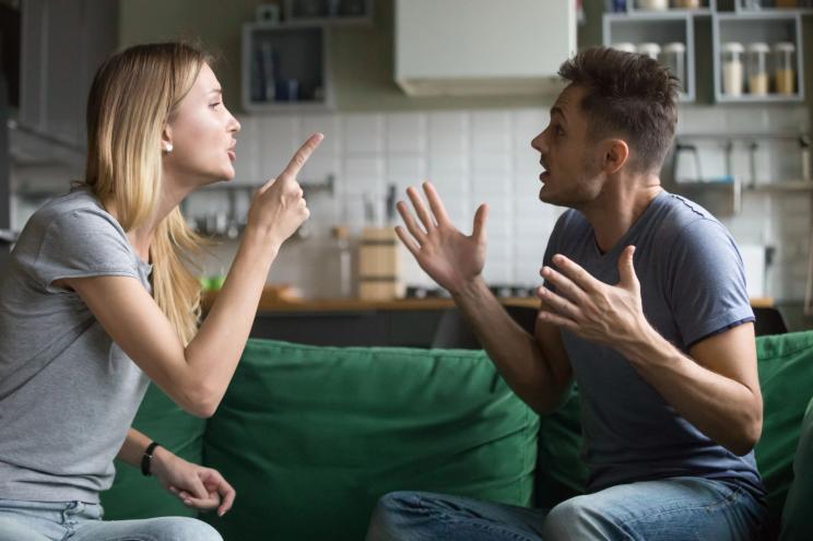 Angry millennial couple arguing shouting blaming each other of problem.