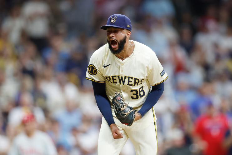 Devin Williams #38 of the Milwaukee Brewers celebrating a strikeout in a game against the Philadelphia Phillies