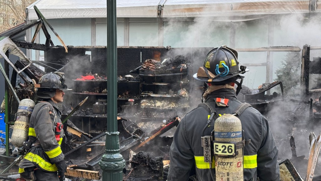 Firefighters at the scene of a raging blaze at Bryant Park's holiday market.