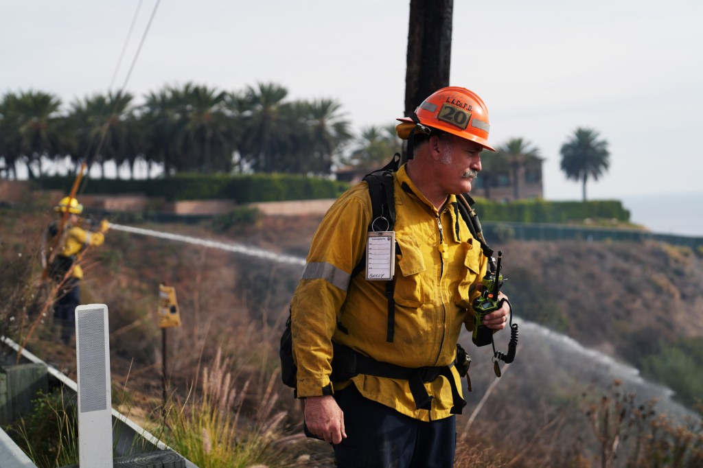 General view of wildfires with Cher's home in the background.