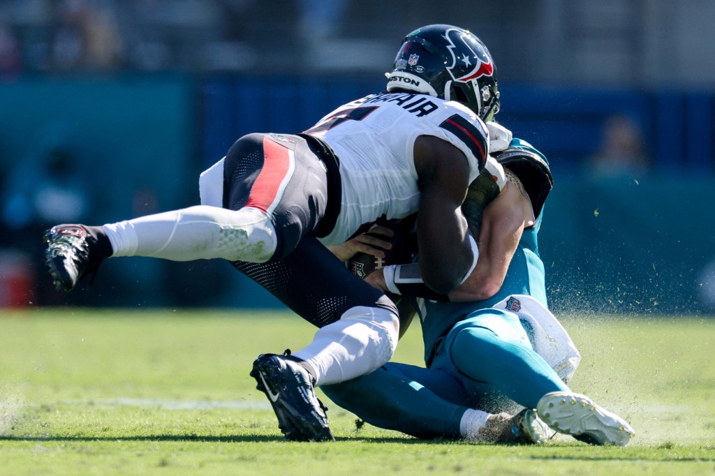 Azeez Al-Shaair hits Trevor Lawrence.