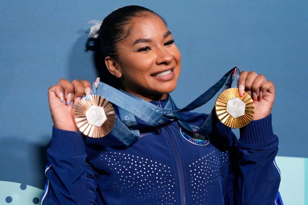 Jordan Chiles holds up her medals after the women's artistic gymnastics individual apparatus finals Bercy Arena at the 2024 Summer Olympics, August 5, 2024, in Paris, France. 