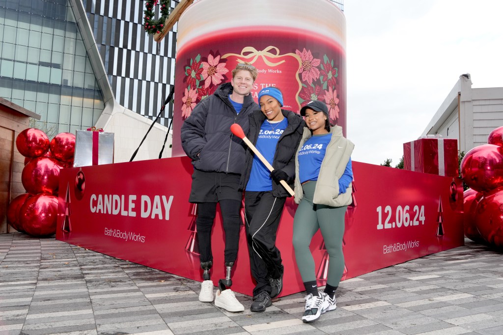 (L-R) Hunter Woodhall, Tara Davis-Woodhall and Jordan Chiles light the candle at the end of the Torch Run as Bath & Body Works counts down to Candle Day in New York City. 
