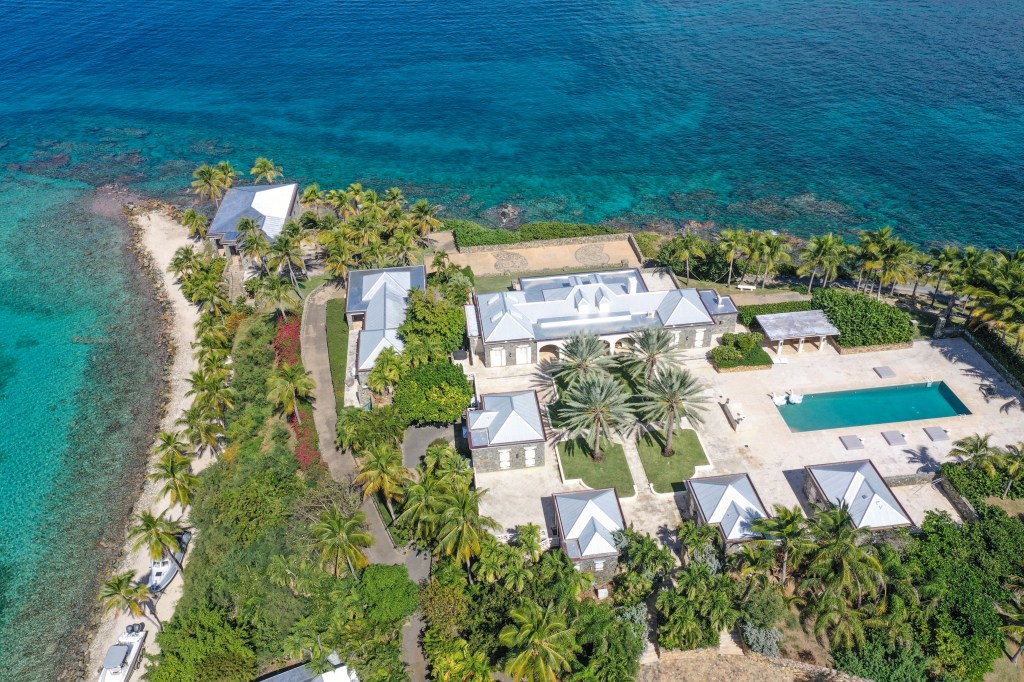 Large building on Little Saint James, private island in the US Virgin Islands, next to a body of water.